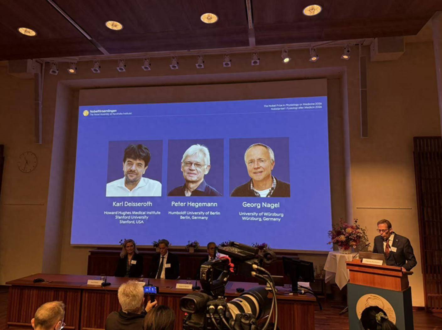 Nobel Assembly announcement screen showing Karl Deisseroth, Peter Hegemann and Georg Nagel as the 2026 medicine laureates